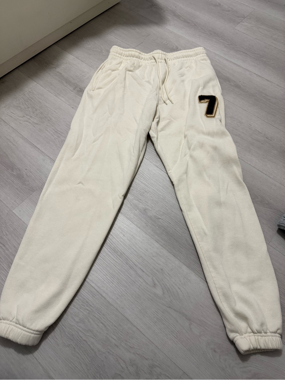 SHEIN Cream Track Pants with Black & Gold '7' Patch